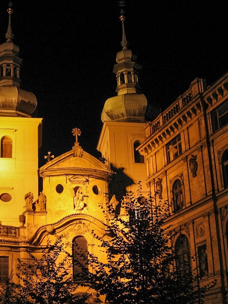 Historic Prague building illuminated at night, part of Ghosts and Legends tour.