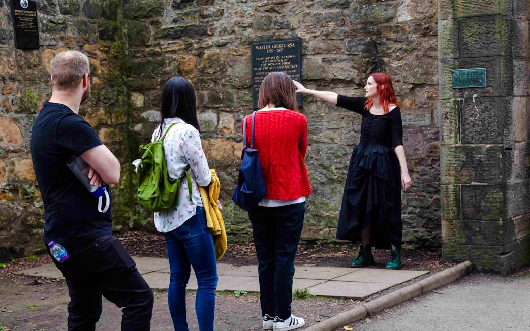 Guide explaining historical site to guests on the Terror Tour in Edinburgh.