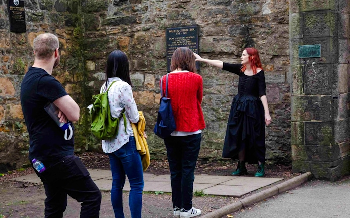 Guide explaining historical site to guests on the Terror Tour in Edinburgh.