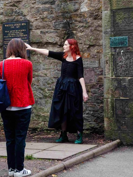Guide explaining historical site to guests on the Terror Tour in Edinburgh.
