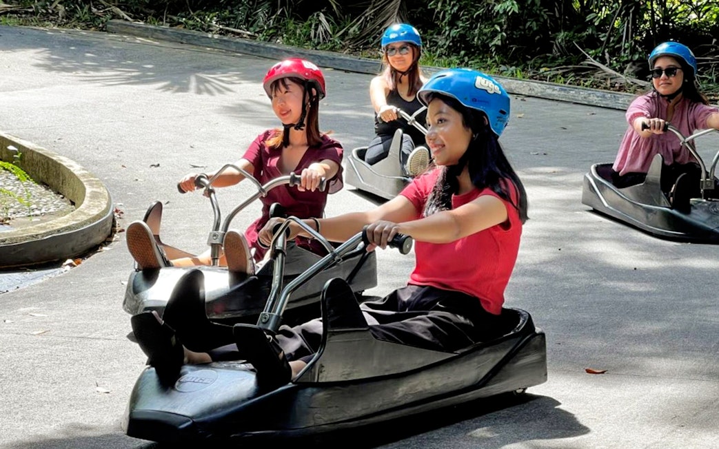 People enjoying a luge ride at Skyline Luge Kuala Lumpur.