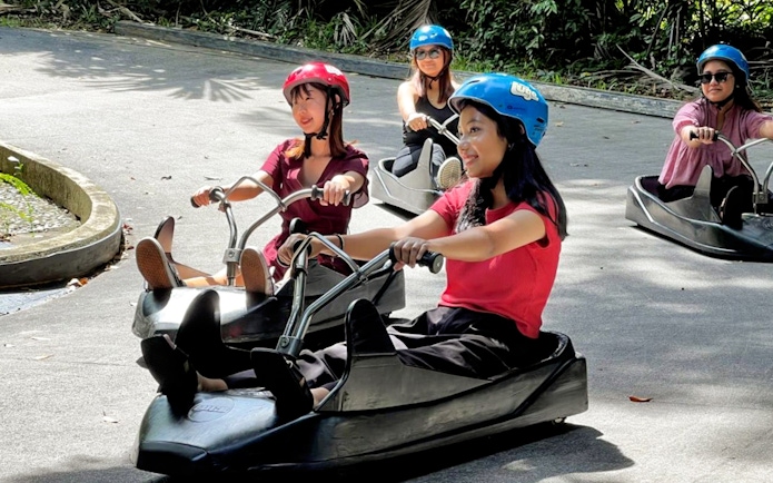 People enjoying a luge ride at Skyline Luge Kuala Lumpur.