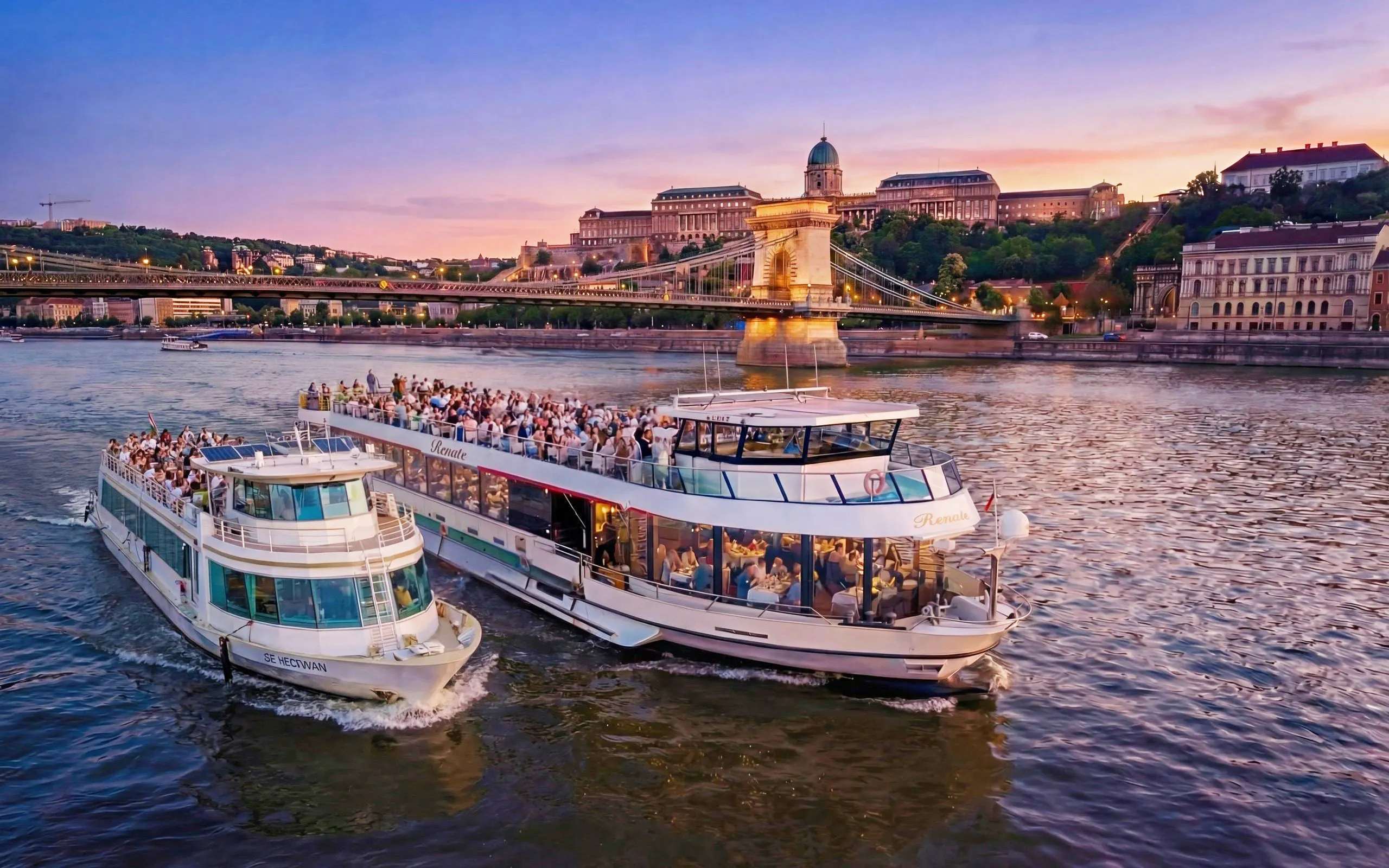 Cruise ships on Danube River with Budapest skyline at sunset.