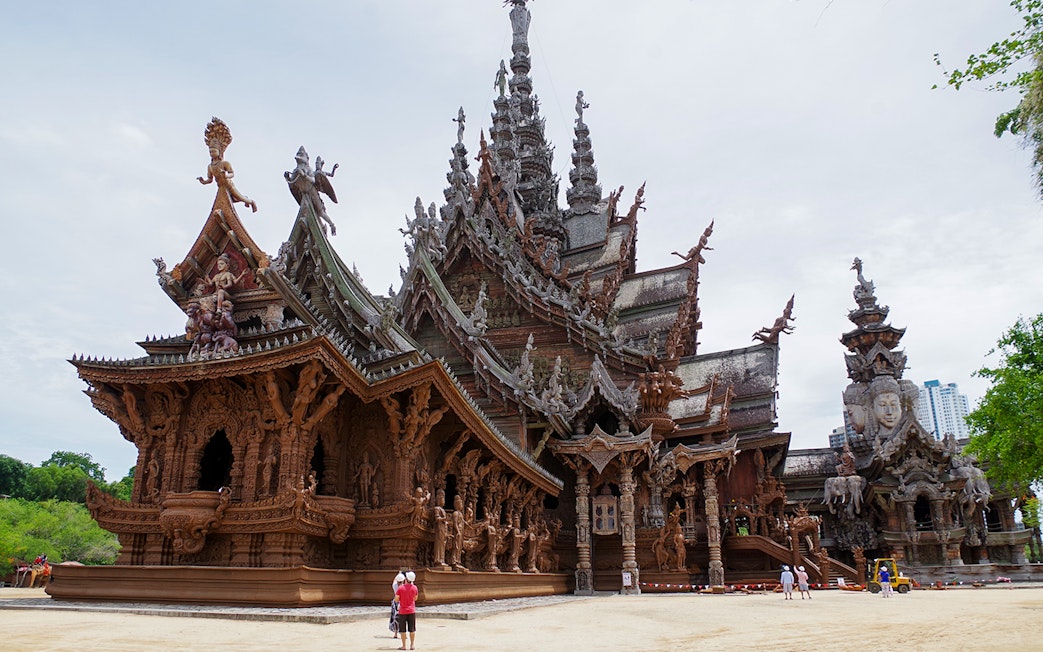 Sanctuary of Truth in Pattaya, Thailand, showcasing intricate wooden carvings and ornate architecture.