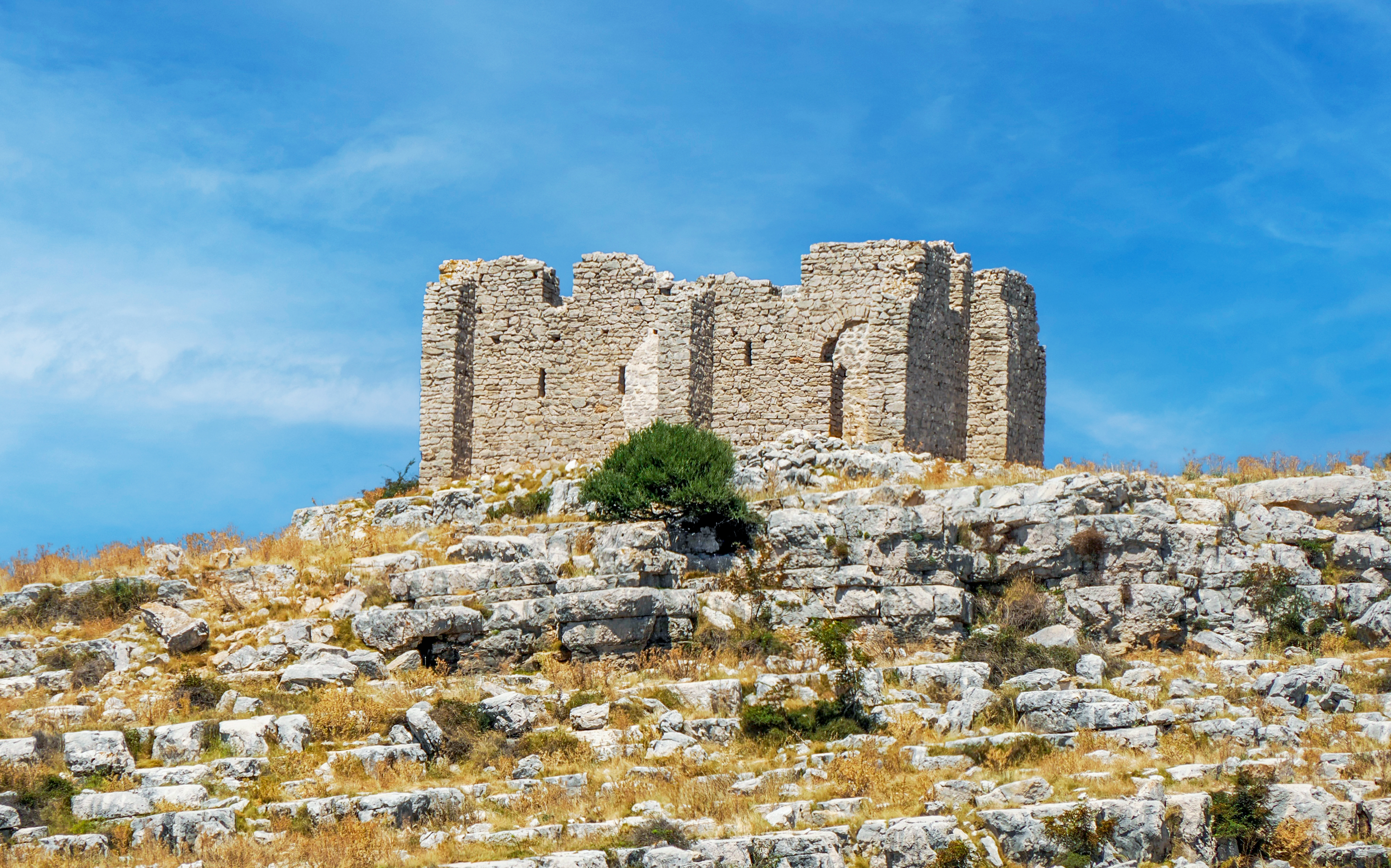 Old stone ruins on a rocky hill in Kornati National Park, Croatia.