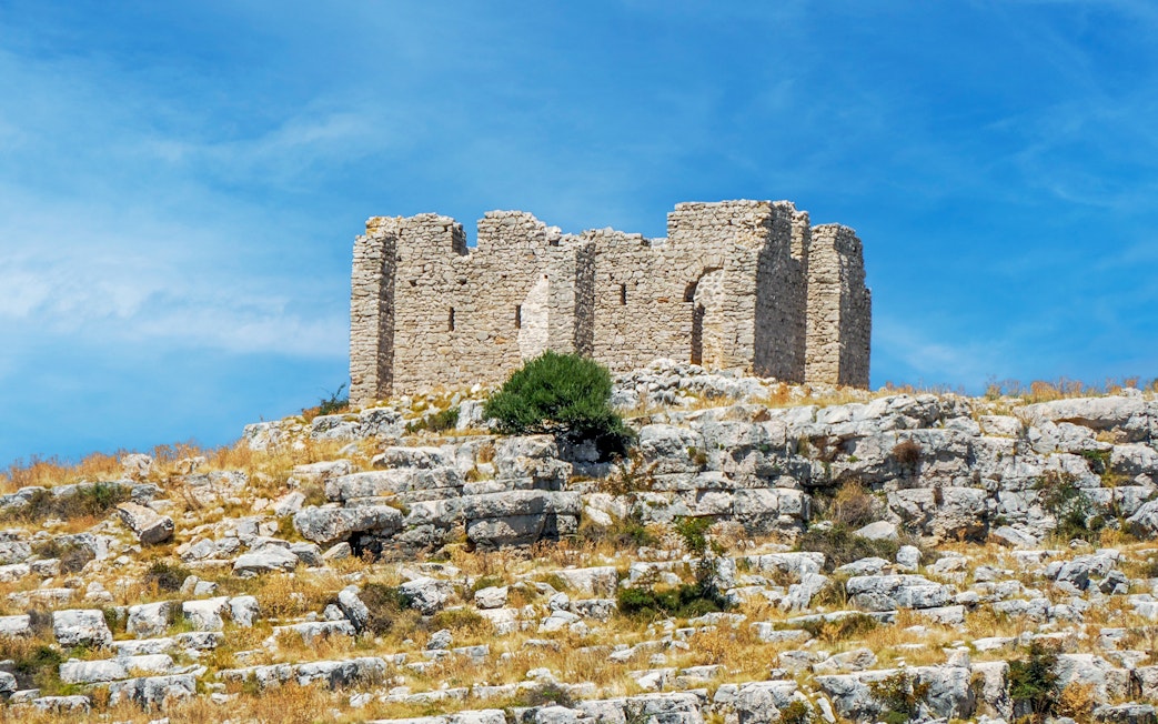 Old stone ruins on a rocky hill in Kornati National Park, Croatia.