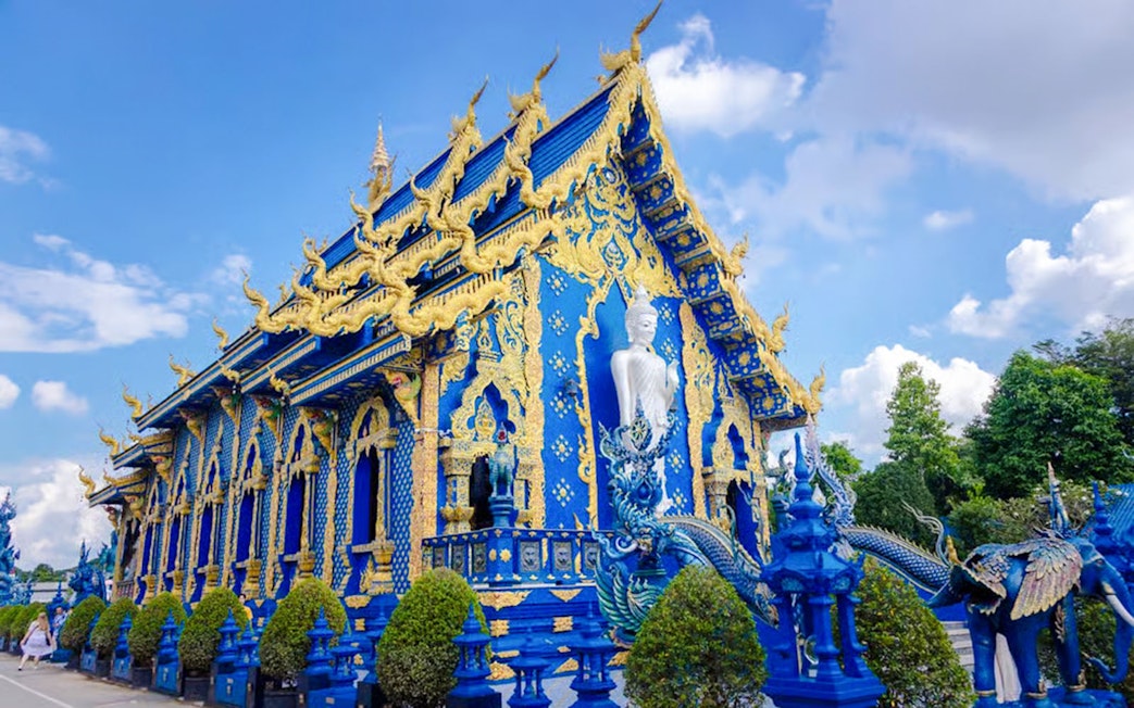 Blue Temple (Wat Rong Sua Ten) exterior with intricate gold details, Chiang Rai, Thailand.