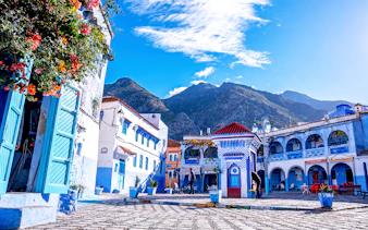 Chefchaouen's blue buildings and mountain backdrop on a full-day trip from Fez.