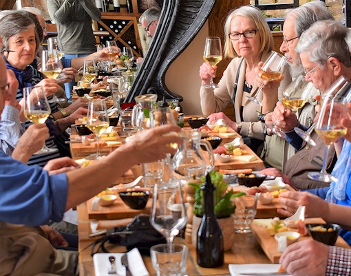 Group enjoying wine tasting at a long table in Diocletian's Palace, Split.