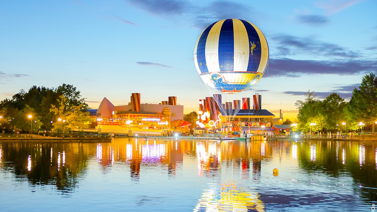Hot air balloon at Disney Village PanoraMagique reflecting on the water at sunset.