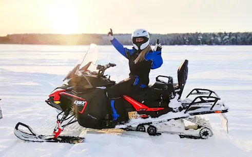 Snowmobiler giving thumbs up on Arctic safari in Rovaniemi.