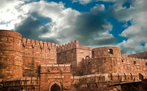 Agra Fort under cloudy sky, part of 3-day Golden Triangle tour.
