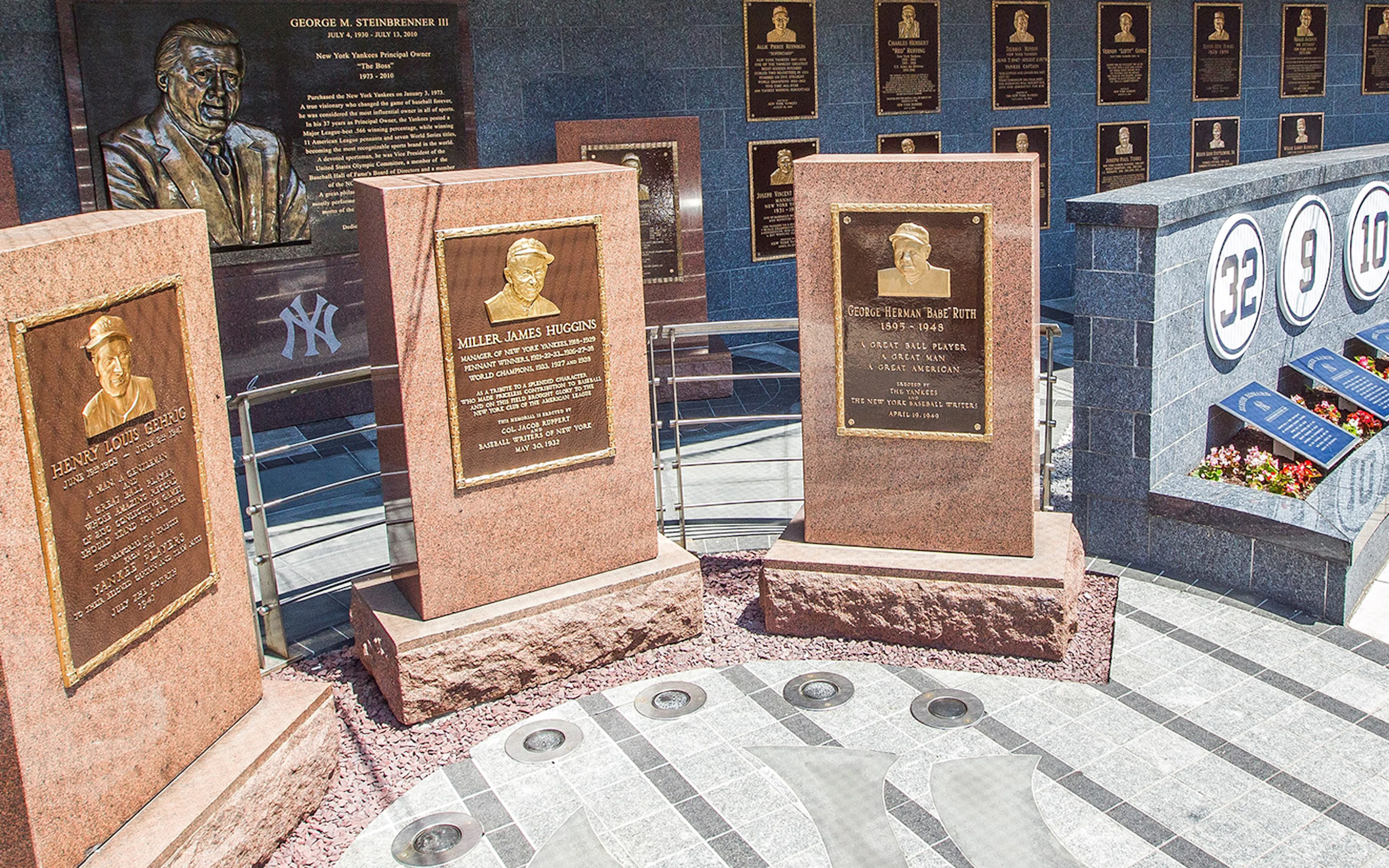 Yankees Monument Park plaques honoring Lou Gehrig, Miller Huggins, and Babe Ruth.