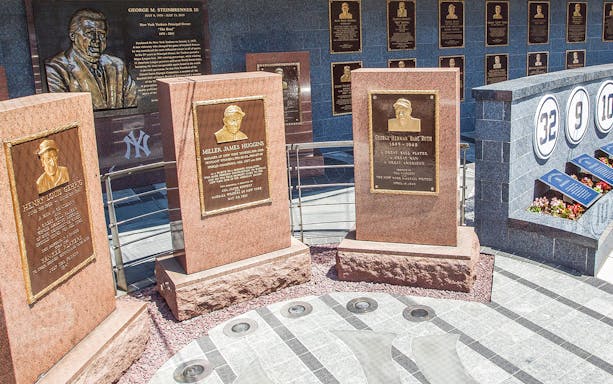 Yankees Monument Park plaques honoring Lou Gehrig, Miller Huggins, and Babe Ruth.