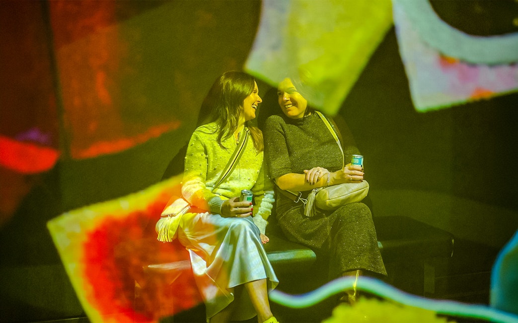 Visitors enjoying exhibit at Frameless Lates event.