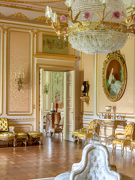 Liria Palace interior with ornate chandelier, gilded furniture, and classical paintings.