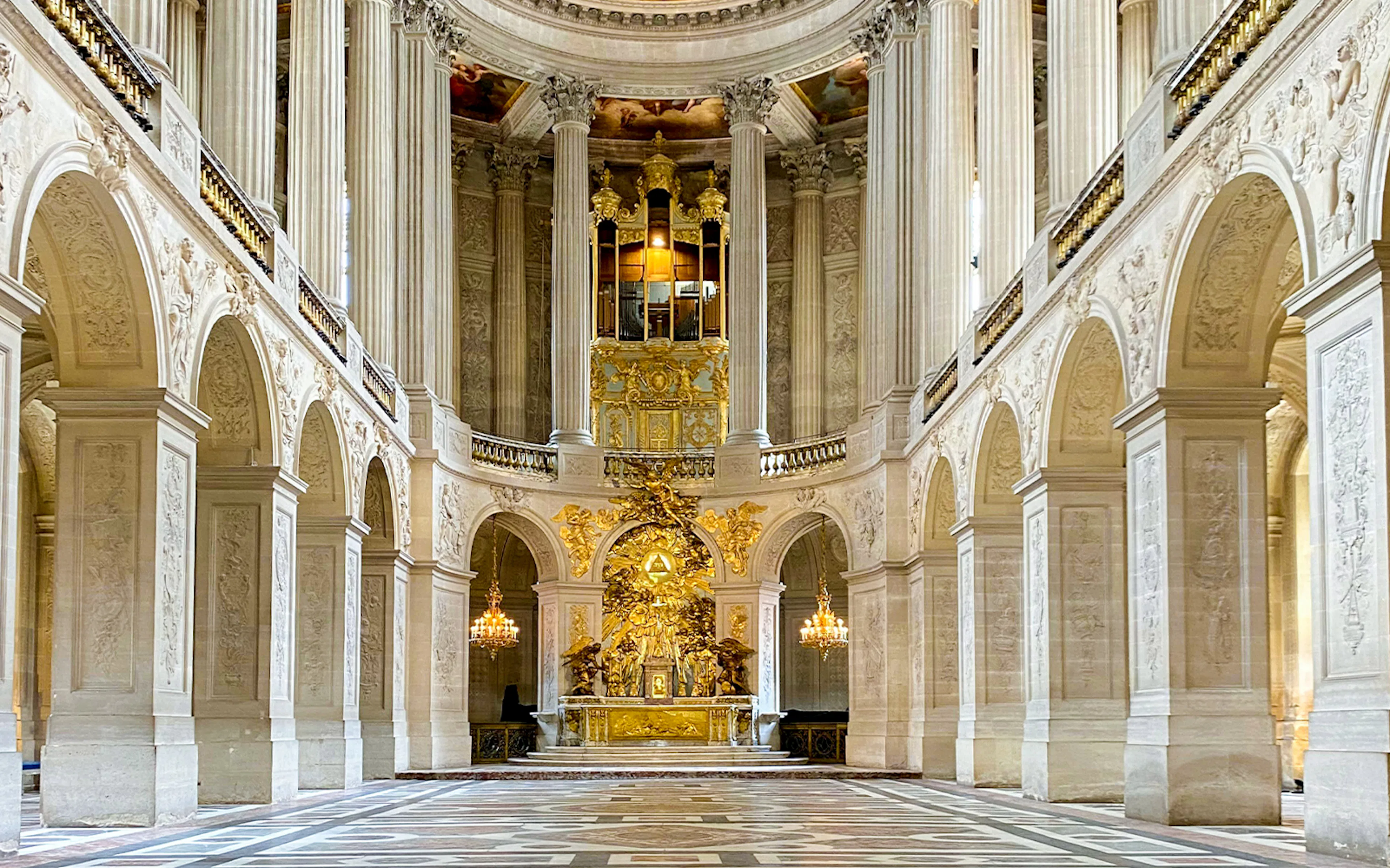 Royal Chapel of Versailles nave with ornate ceiling and grand organ in Versailles, France.