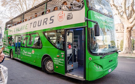 Green Line hop-on hop-off bus in Rome with passengers on the upper deck.