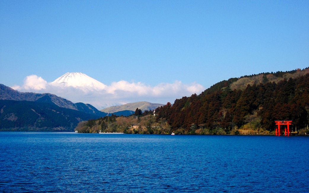 Mount Fuji view from Lake Ashi with red torii gate, Japan.