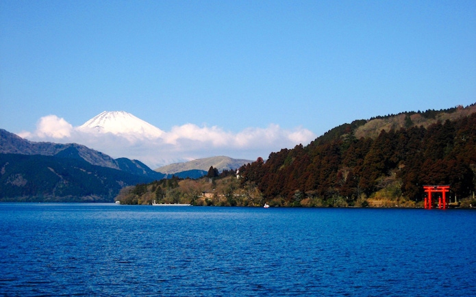 Mount Fuji view from Lake Ashi with red torii gate, Japan.