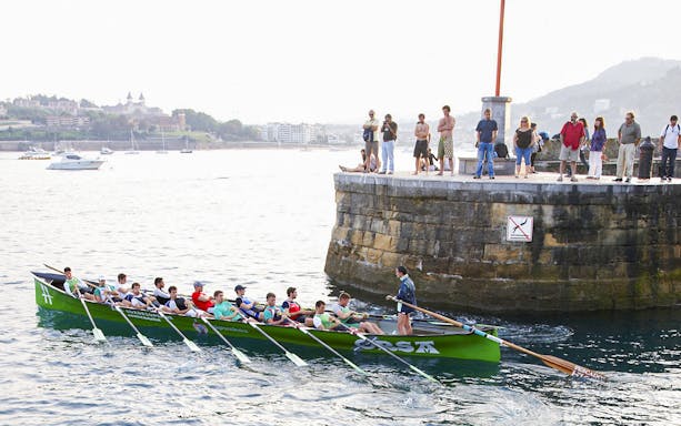 Rowing team near San Sebastian coast during guided tour from Bilbao.