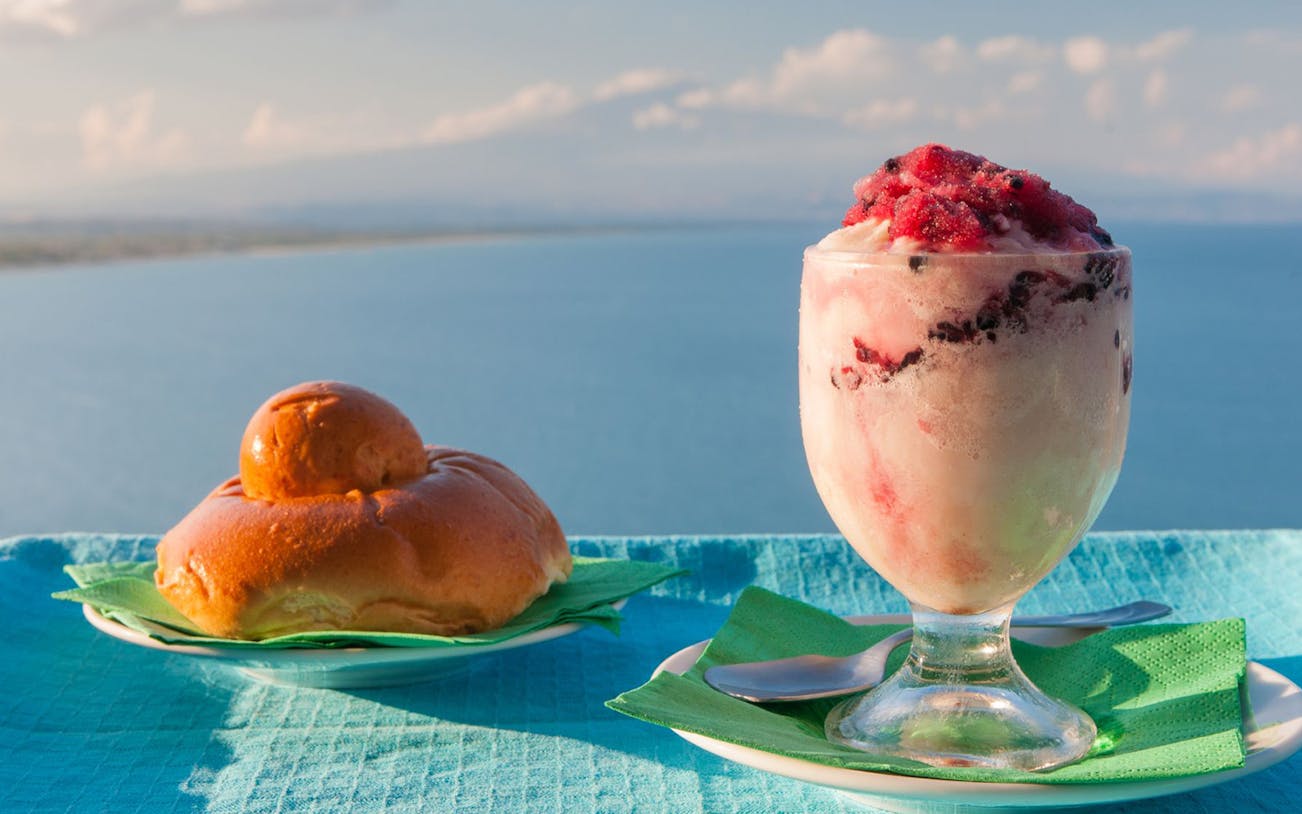 Granita and brioche with sea view in Palermo, Sicily.