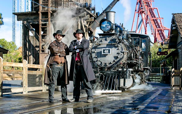 Cowboys in front of a steam train at Ghost Town Alive, Knott's Berry Farm.