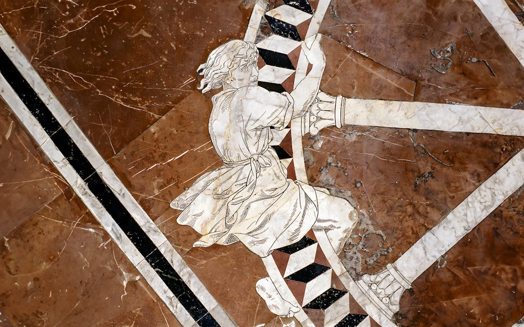 Marble inlay artwork on Siena Cathedral floor depicting a historical figure.