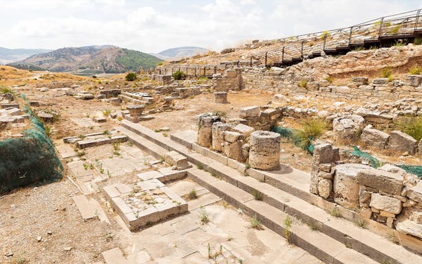 Ancient ruins at Segesta Archaeological Park with stone columns and pathways in Sicily.