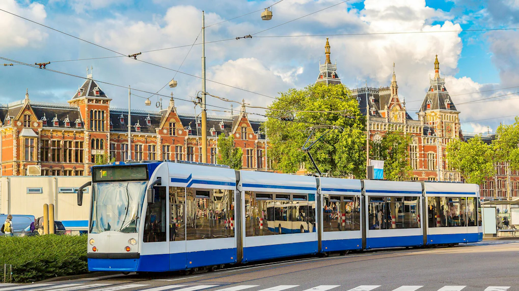 City tram passing by Amsterdam Central Station.