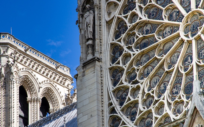 Notre Dame's intricate rose window with detailed stone carvings.
