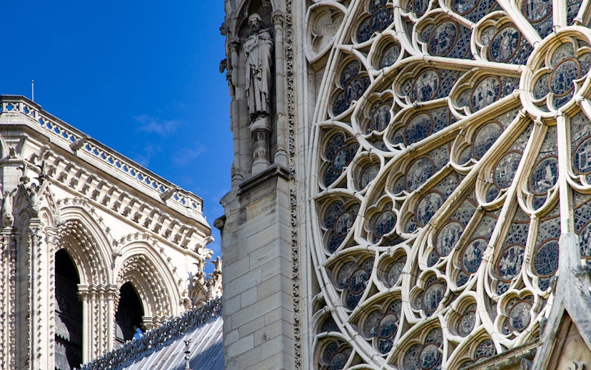 Notre Dame's intricate rose window with detailed stone carvings.
