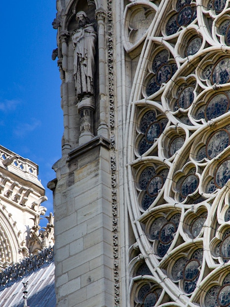 Notre Dame's intricate rose window with detailed stone carvings.