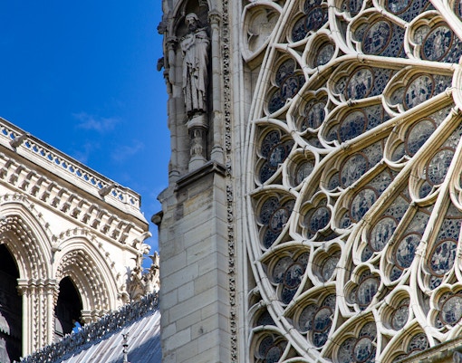 Notre Dame Cathedral exterior with rose windows in Paris, France.