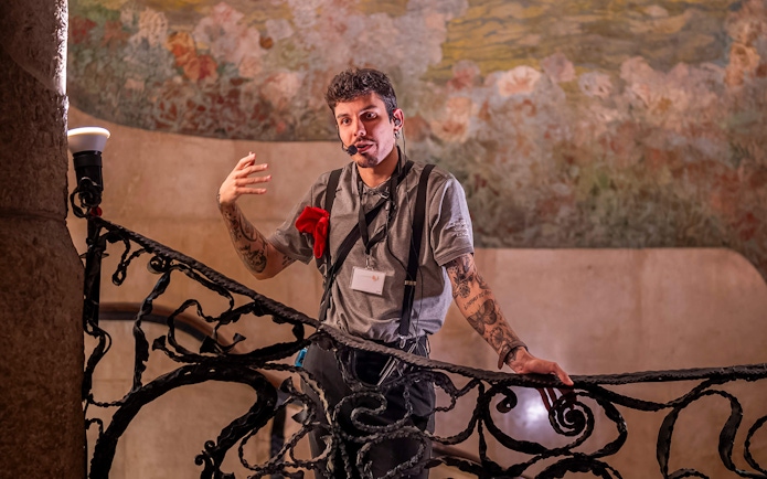 Guide explaining details during La Pedrera Casa Mila night tour in Barcelona.