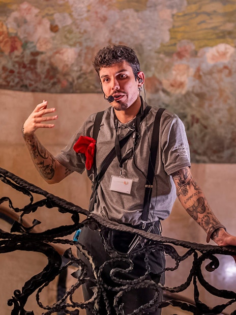 Guide explaining details during La Pedrera Casa Mila night tour in Barcelona.