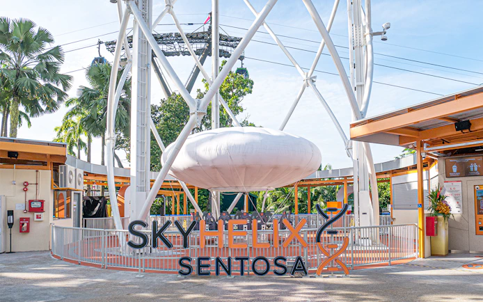 SkyHelix Sentosa ride structure with surrounding greenery in Singapore.