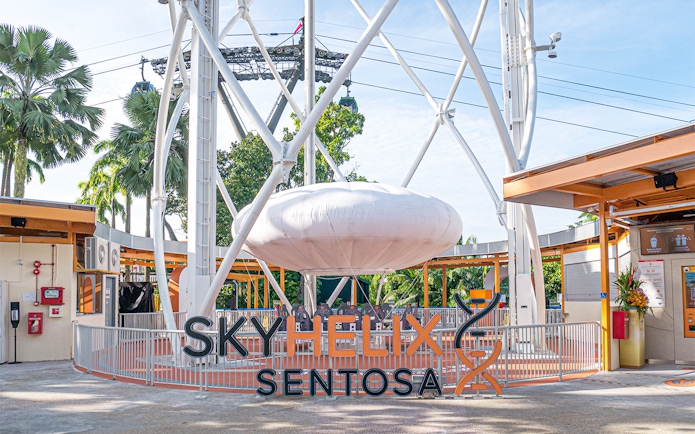 SkyHelix Sentosa ride structure with surrounding greenery in Singapore.
