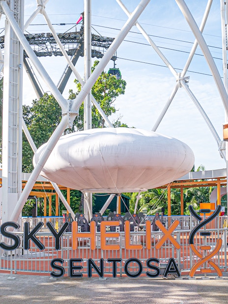 SkyHelix Sentosa ride structure with surrounding greenery in Singapore.