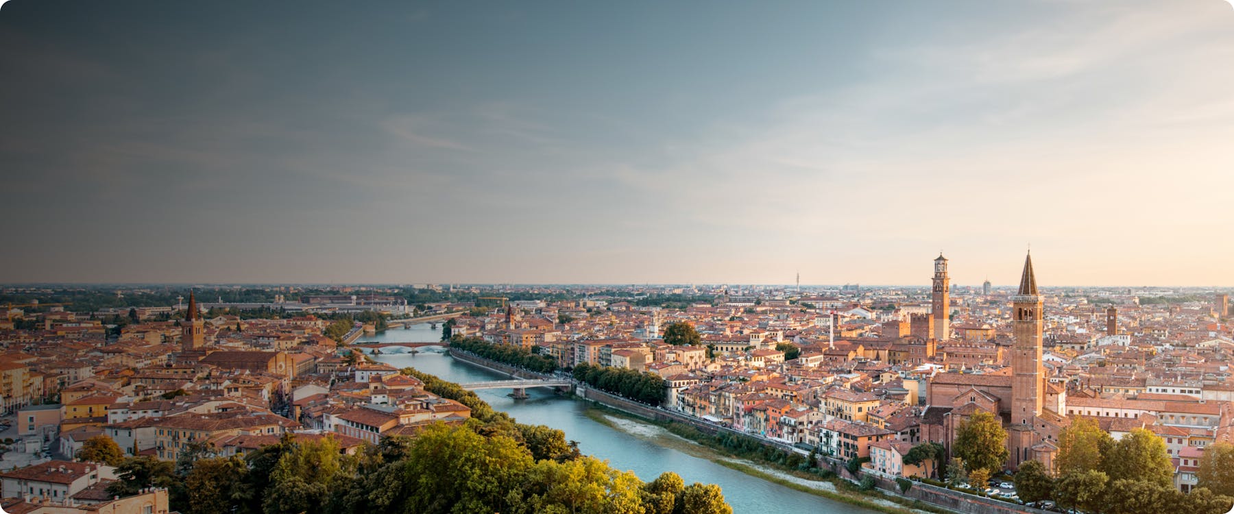Aerial view of Verona with Adige River and historic buildings.