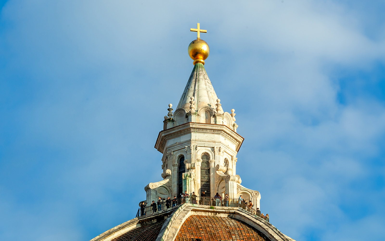 Dome details of Florence Cathedral with cross and observation deck.