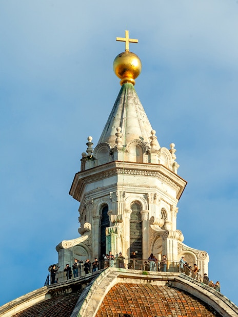 Dome details of Florence Cathedral with cross and observation deck.