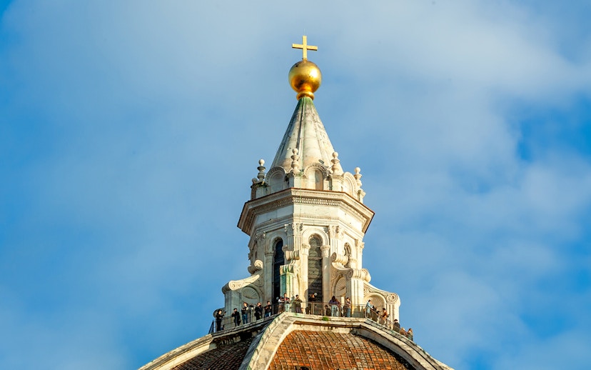 Dome details of Florence Cathedral with cross and observation deck.