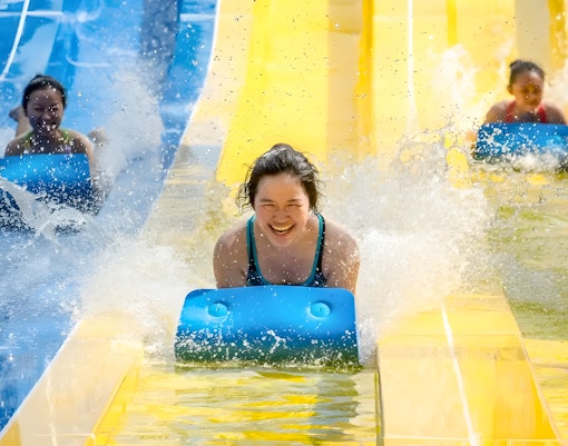Visitors enjoying thrilling rides at ESCAPE Theme Park Penang, a popular tourist attraction in Malaysia