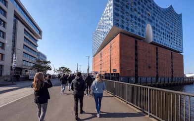 Guided tour group approaching Elbphilharmonie in Hamburg, Germany.