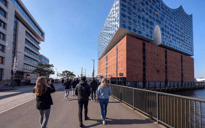 Guided tour group approaching Elbphilharmonie in Hamburg, Germany.