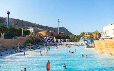 Visitors enjoying the water park at Terra Mitica Benidorm with slides and attractions.