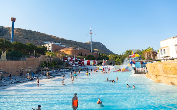 Visitors enjoying the water park at Terra Mitica Benidorm with slides and attractions.