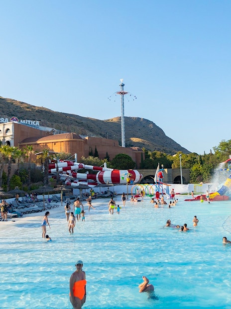 Visitors enjoying the water park at Terra Mitica Benidorm with slides and attractions.