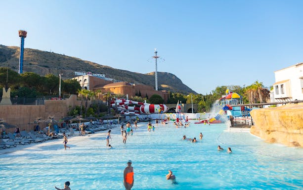 Visitors enjoying the water park at Terra Mitica Benidorm with slides and attractions.